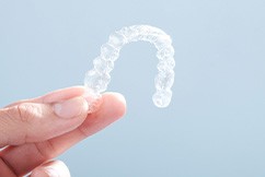 Patient holding clear aligner