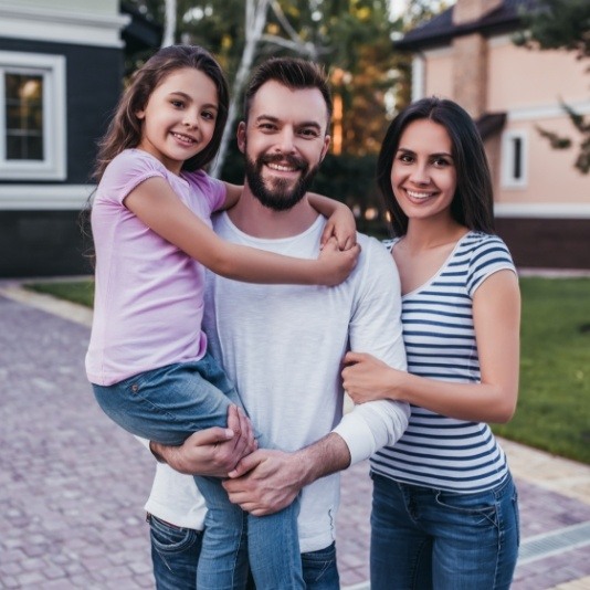 Family of three in their front yard after visiting Slidell dental office