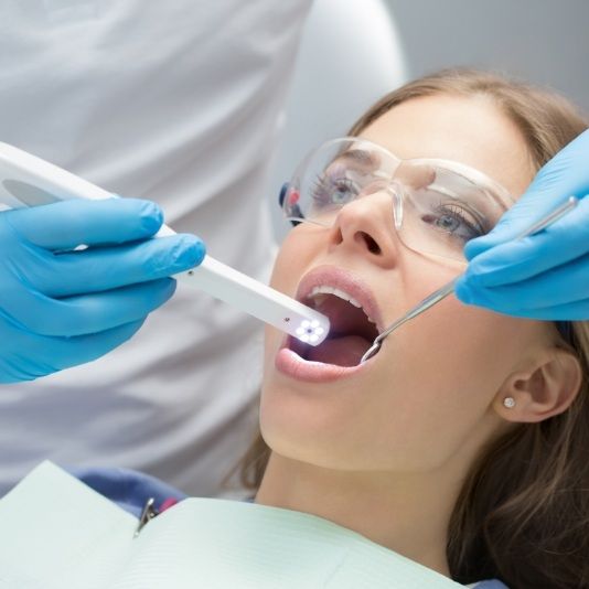 Dentist performing dental exam with advanced dental technology in Slidell