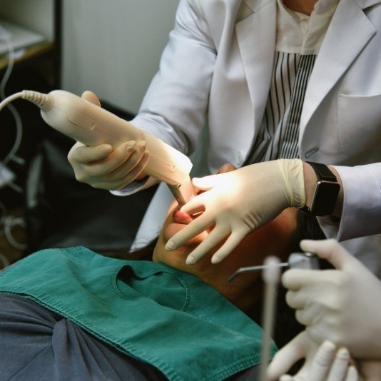 Patient getting digital dental impressions taken of their mouth