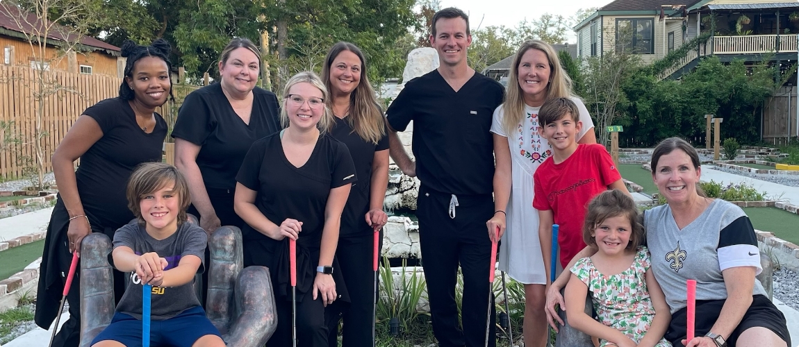 Dentist and dental team at golf course at Slidell community event