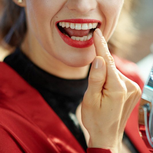 Woman pointing to her tooth