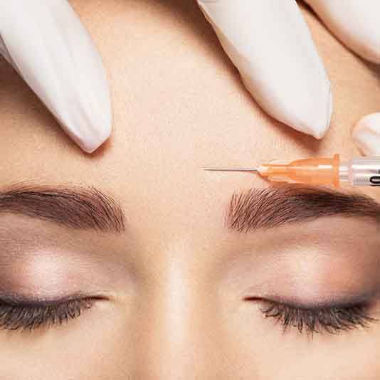 Person getting an injection in their forehead for Botox in Slidell