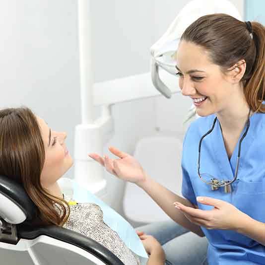 Woman talking to a dentist