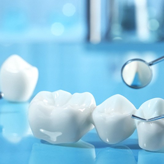 A dental bridge with dental implant parts in the background