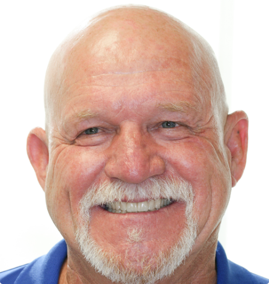 Senior man in blue collared shirt smiling