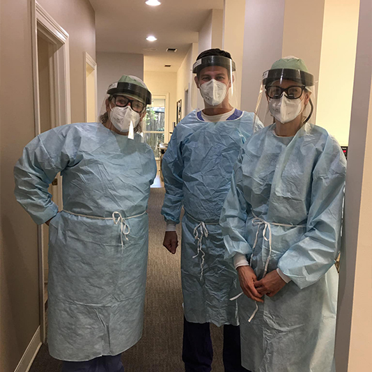 Slidell dentist and two team members wearing personal protective equipment