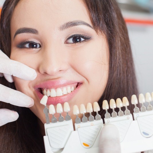 Young woman trying on veneers from her cosmetic dentist in Slidell