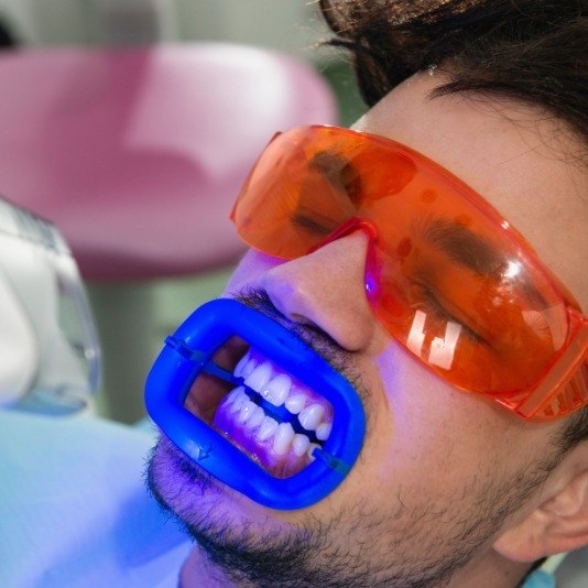 Man getting professional teeth whitening from cosmetic dentist