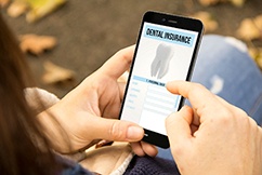 Checking dental insurance form on a cell phone