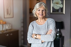 Senior woman smiling with her arms folded
