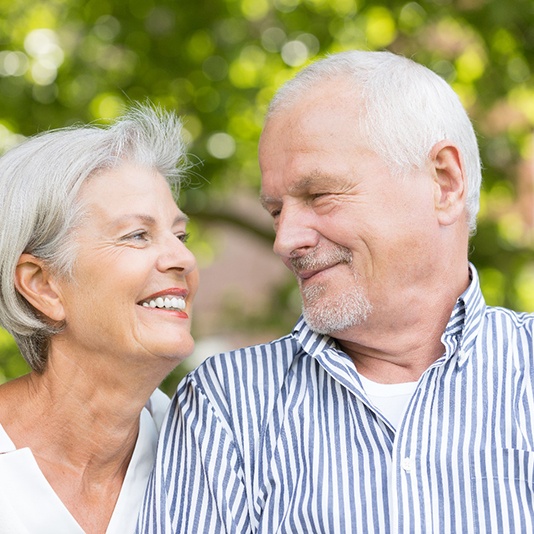 older couple smiling at each other 