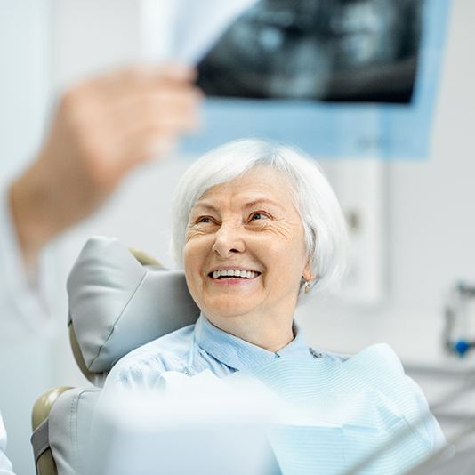 patient smiling while looking at dentist 