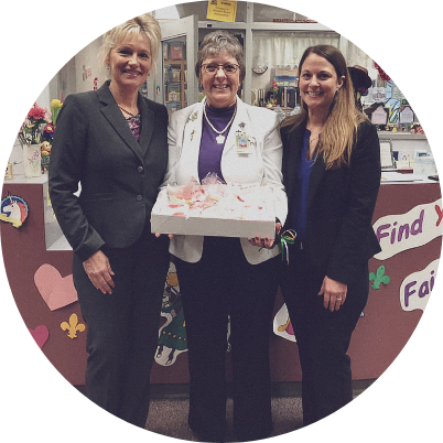 Slidell dental team members holding a cake