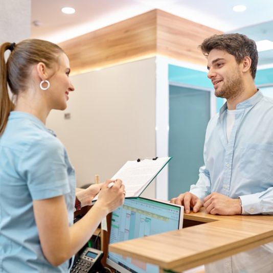 a patient asking the front desk about in-house dental savings 