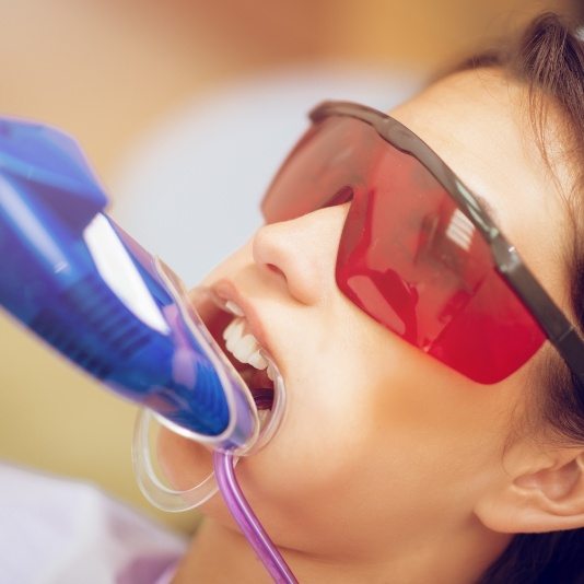 Young girl getting fluoride treatment during preventive dentistry visit