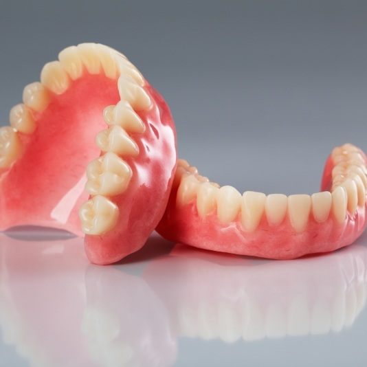Two full dentures on metal table
