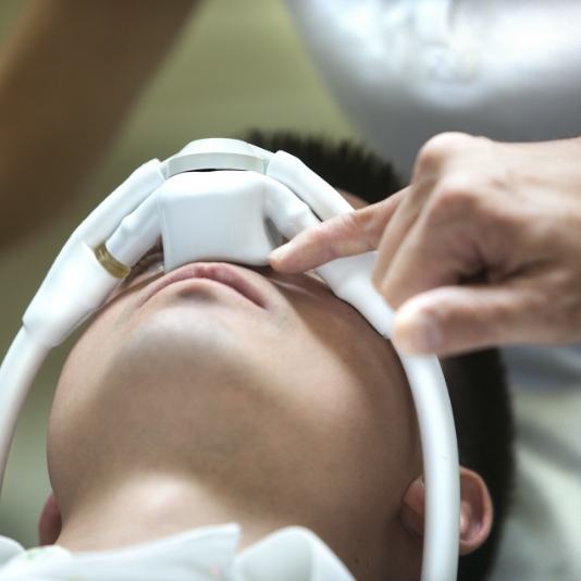 Man laying in dental chair with nitrous oxide sedation mask