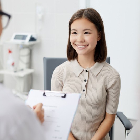 Young woman smiling at her sedation dentist