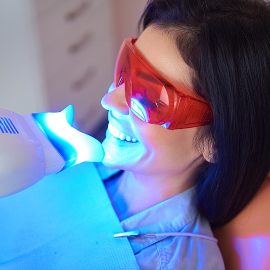 a patient smiling while undergoing teeth whitening