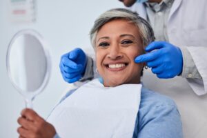 Woman with bright, straight smile after cosmetic dental work