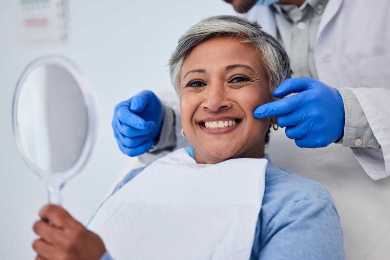 Woman with bright, straight smile after cosmetic dental work