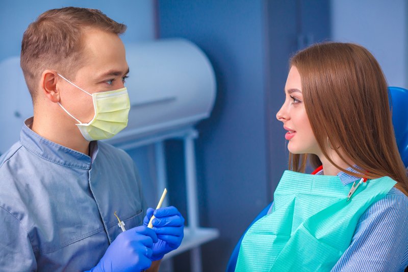 patient consulting with dentist about teeth whitening 